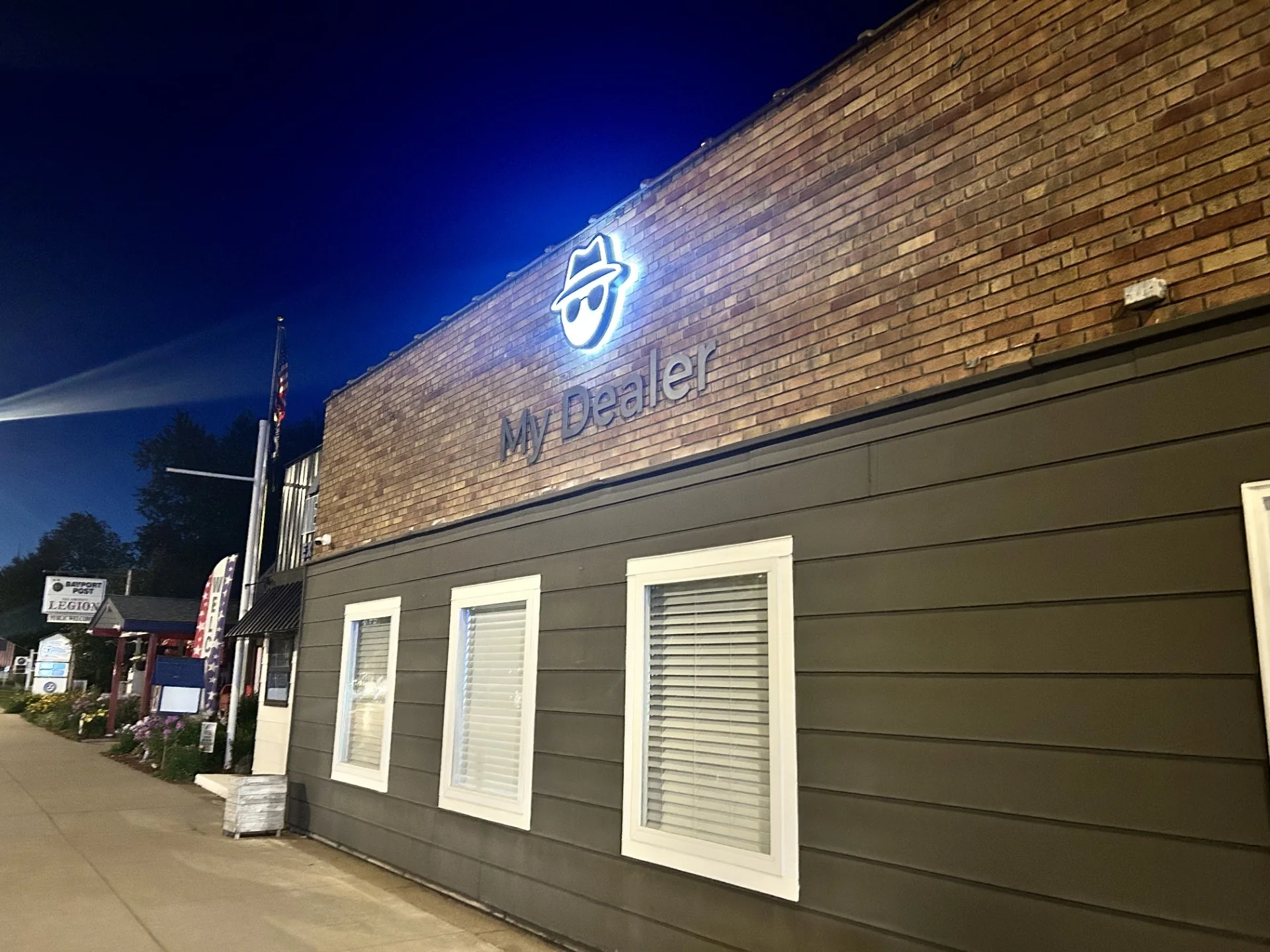 Illuminated My Dealer sign on the Bayport storefront